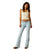 Ariat Women's June Perfect Rise Flare Jean. Woman wearing light blue jeans and a beige top on a white background