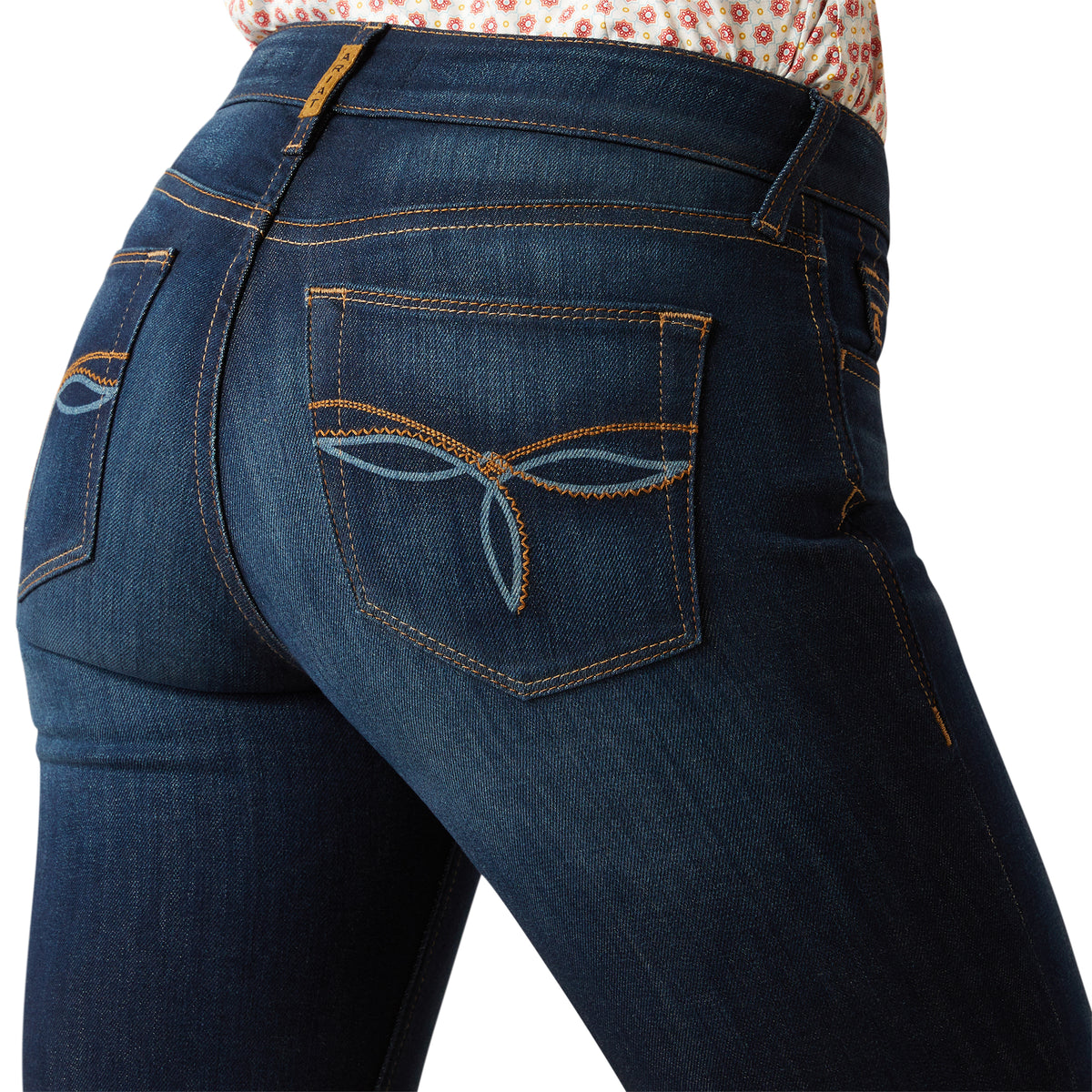 Ariat Women's Juliana Perfect Rise Trouser Jean. Close-up of blue jeans with a white background
