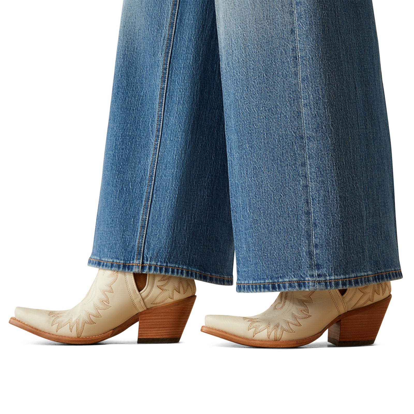 Ariat Women's Jazmine Ultra High-Rise Wide Leg Jean. Beige cowboy boots with brown soles worn with blue jeans on a white background