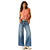 Ariat Women's Jazmine Ultra High-Rise Wide Leg Jean. Woman wearing a red tank top and blue jeans on a white background