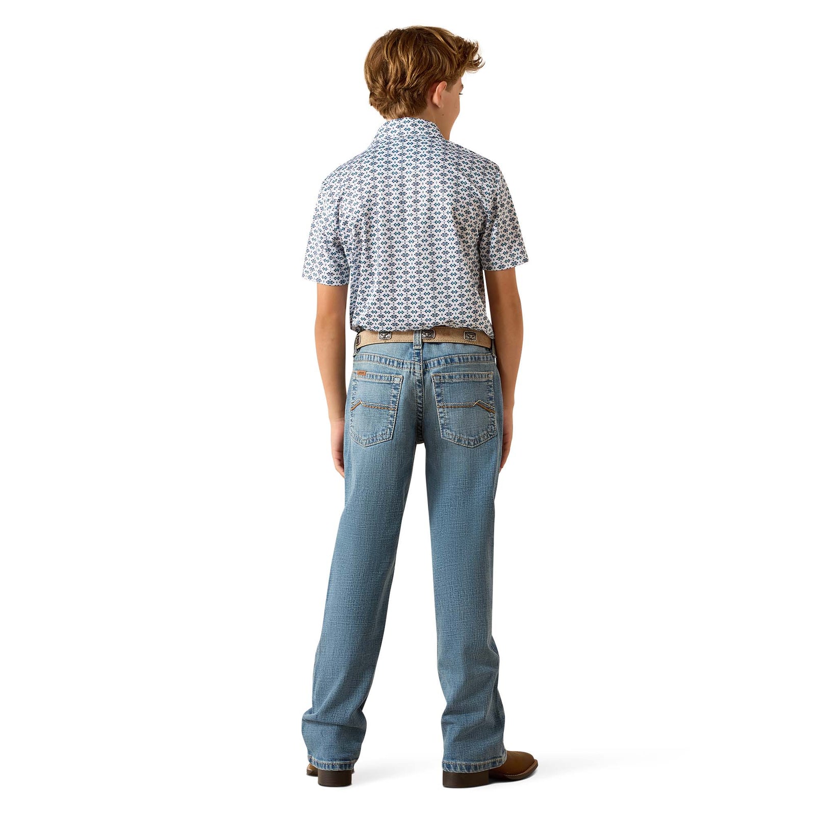 Person wearing blue jeans and a patterned shirt on a white background