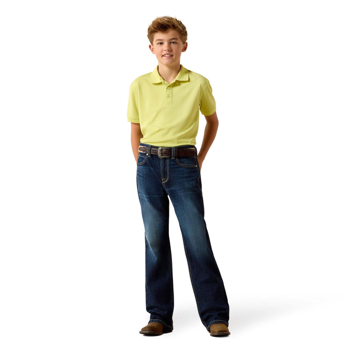 Young boy wearing a yellow polo shirt and blue jeans on a white background