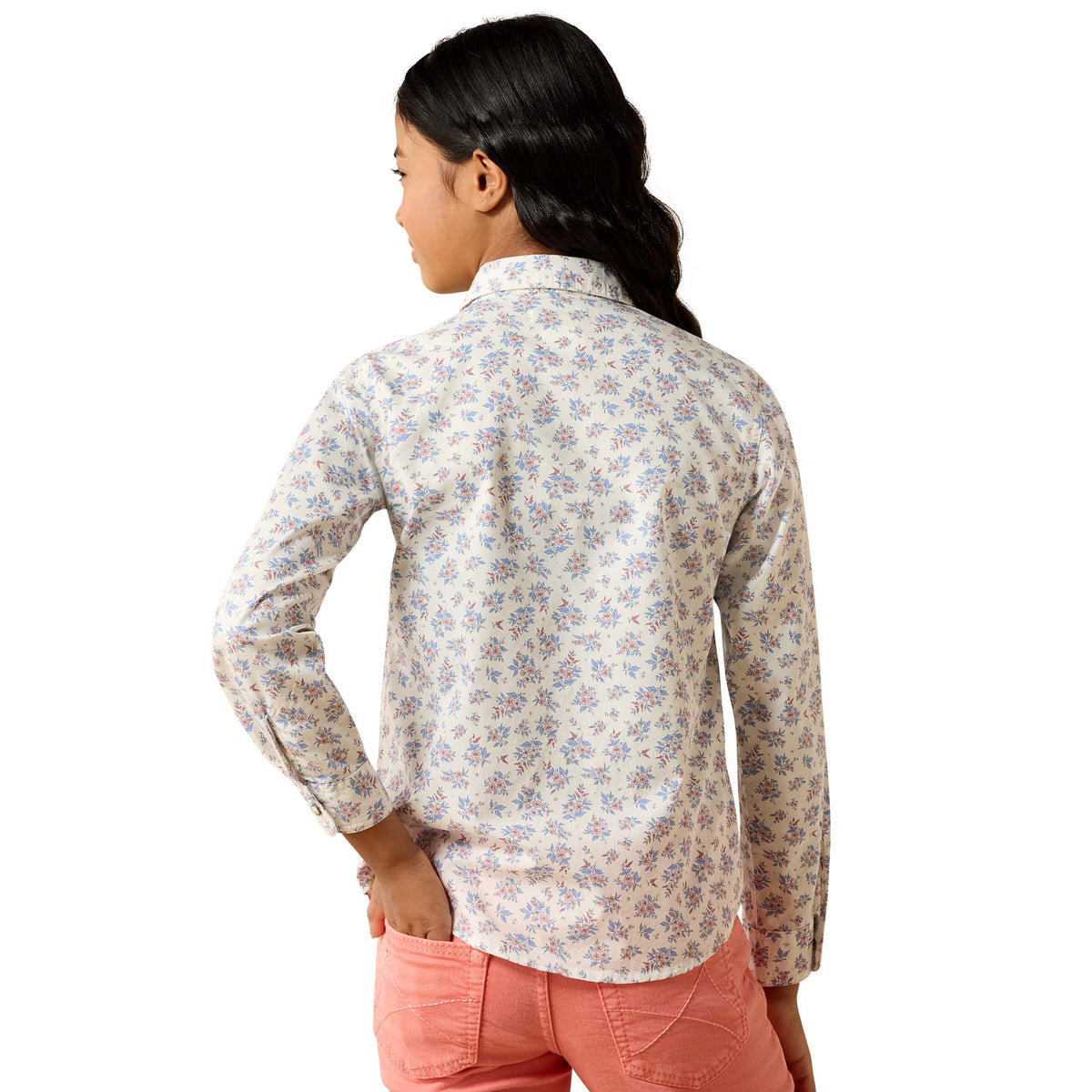 Woman wearing a floral shirt and pink pants on a white background