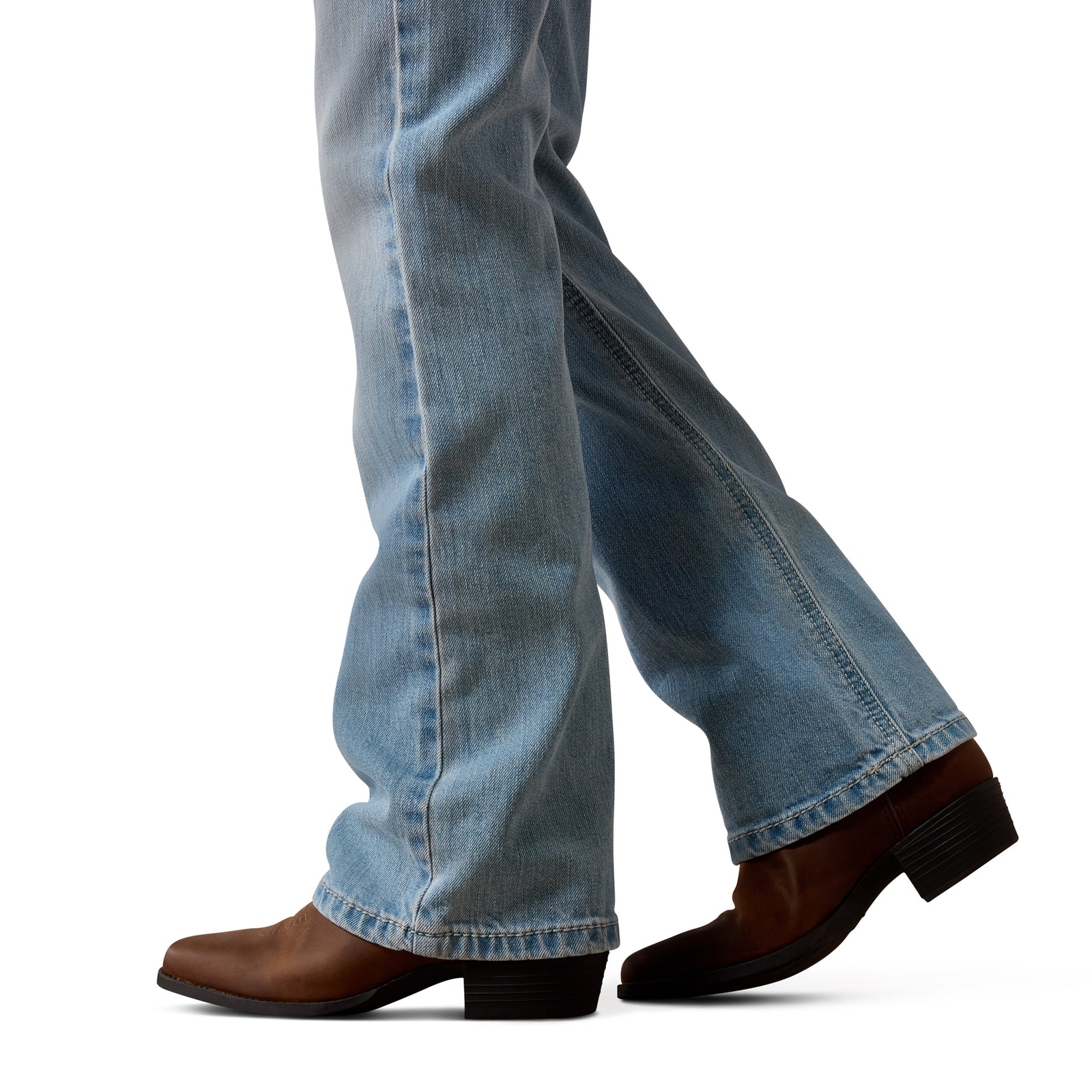 Close-up of blue jeans and brown shoes on a white background