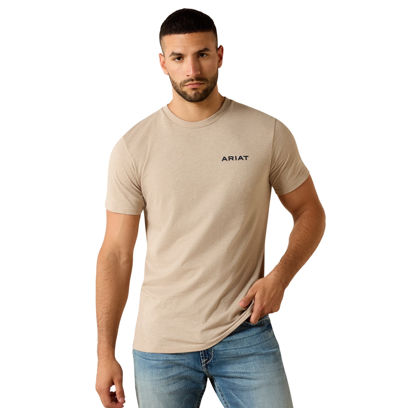 Man wearing a beige t-shirt with a geometric design and 'Ariat' branding on the back.