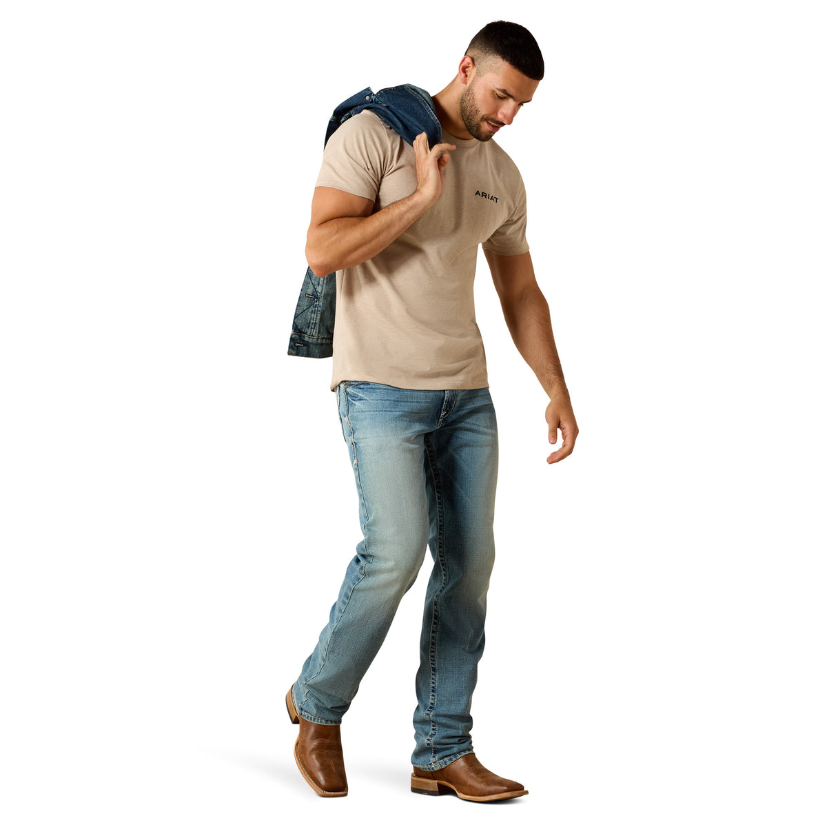 Man wearing a beige t-shirt, blue jeans, and brown boots on a white background