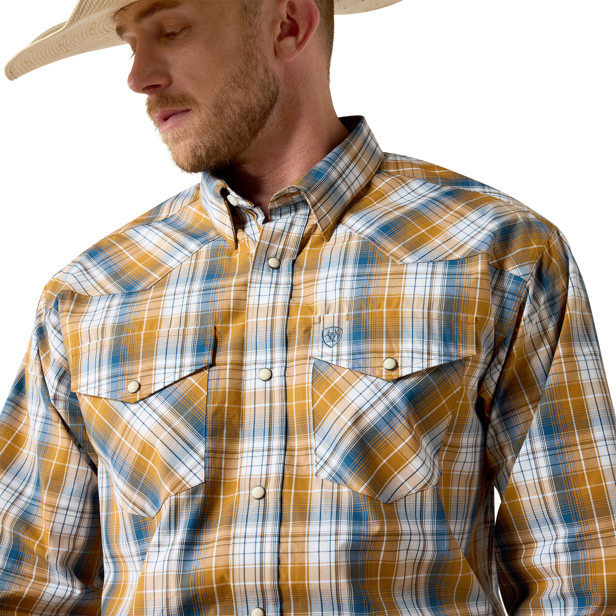 Man wearing a plaid shirt with a neutral background