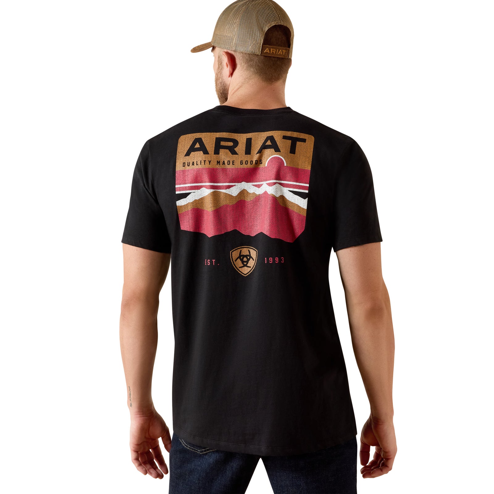 Man wearing a black Ariat t-shirt with a graphic design on the back, standing against a white background.