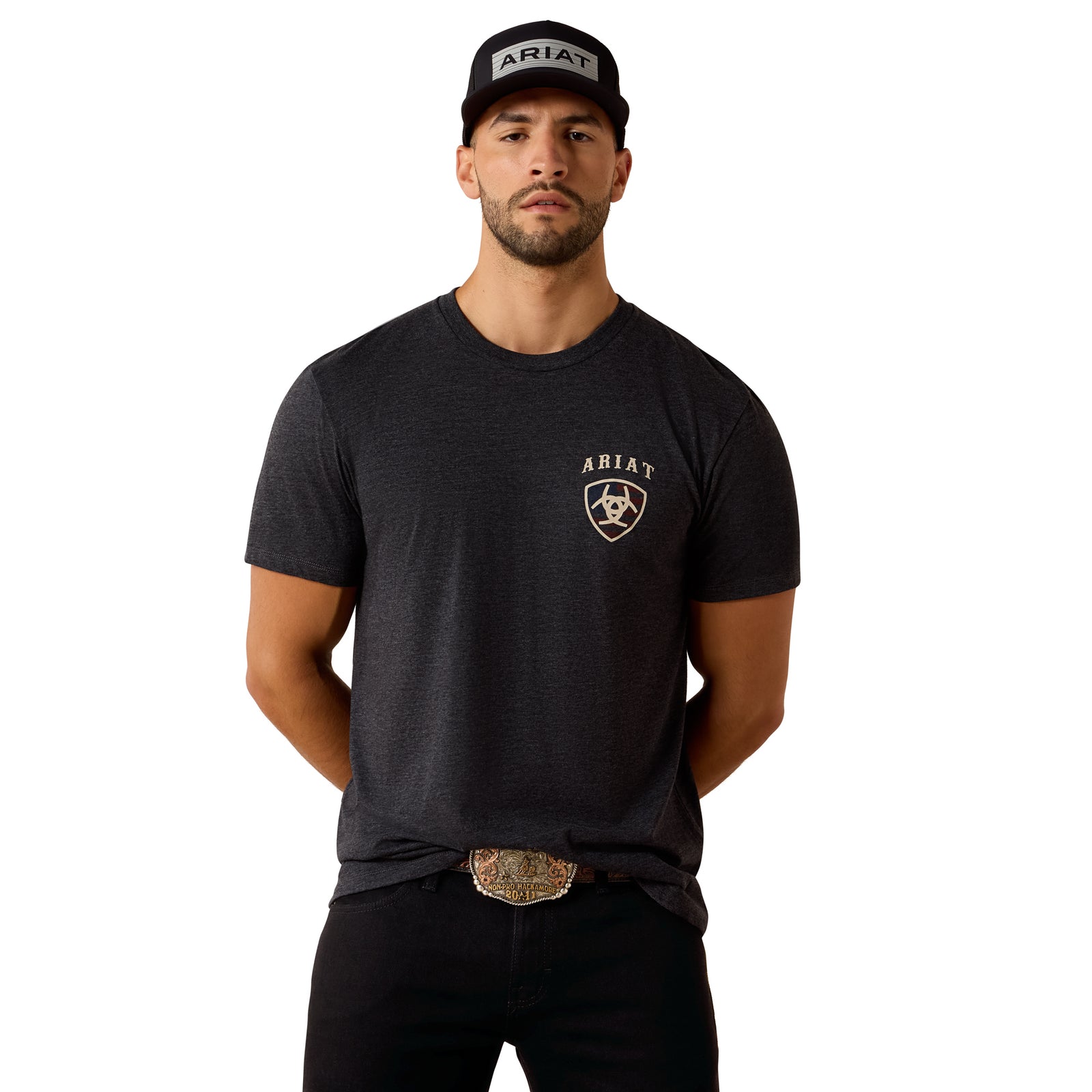 Man wearing a black t-shirt with Ariat logo and a cap on a white background