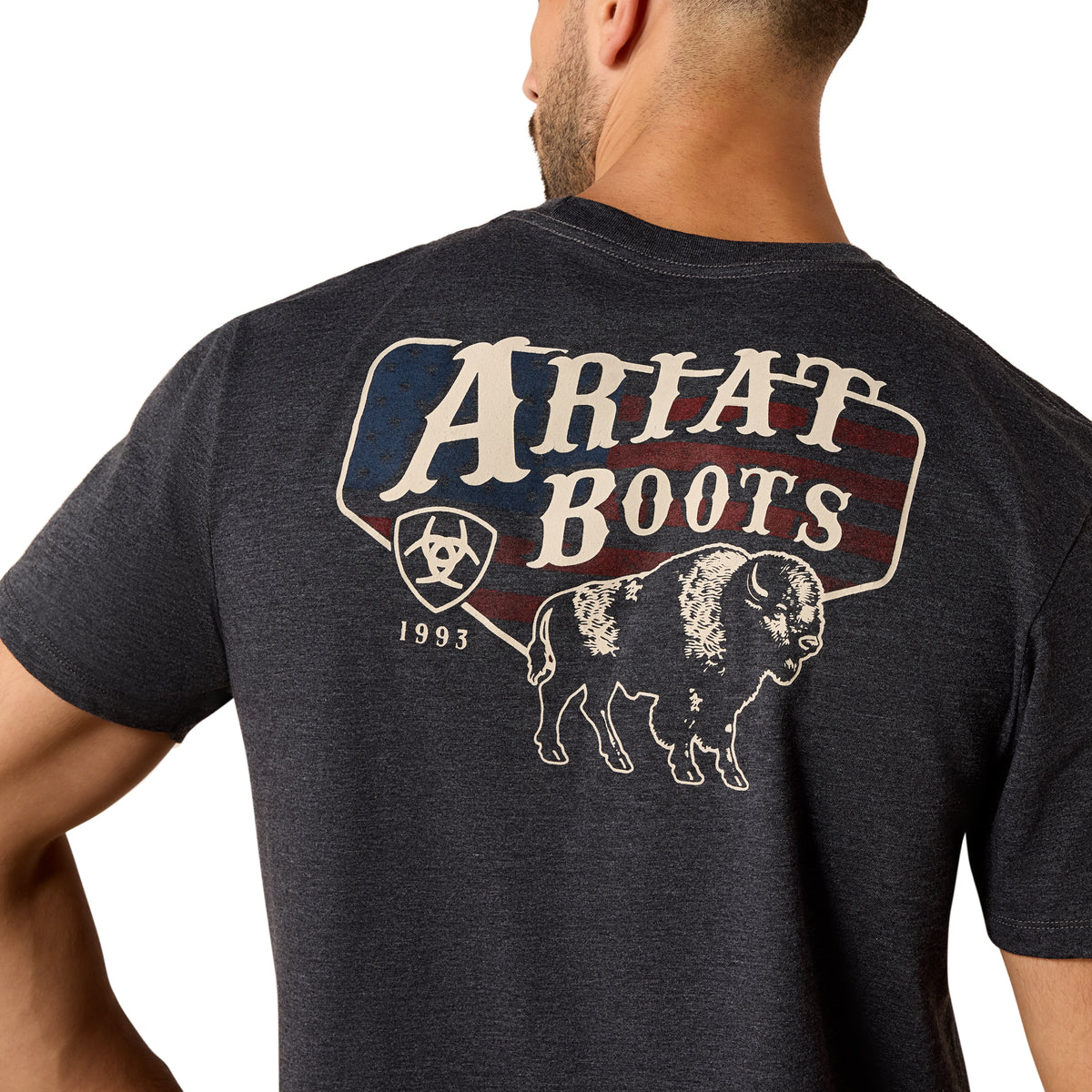 Person wearing a dark gray t-shirt with 'Ariat Boots' logo on the back