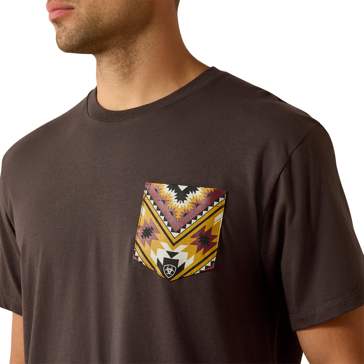 Brown t-shirt with a colorful geometric pocket design on a white background