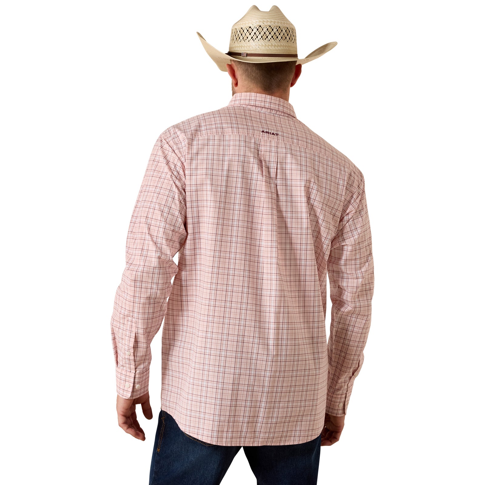 Man wearing a pink plaid shirt, blue jeans, and a cowboy hat on a white background