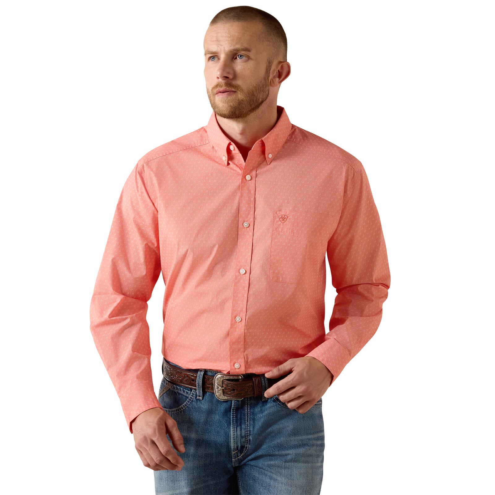 Man wearing a coral button-up shirt and blue jeans on a white background