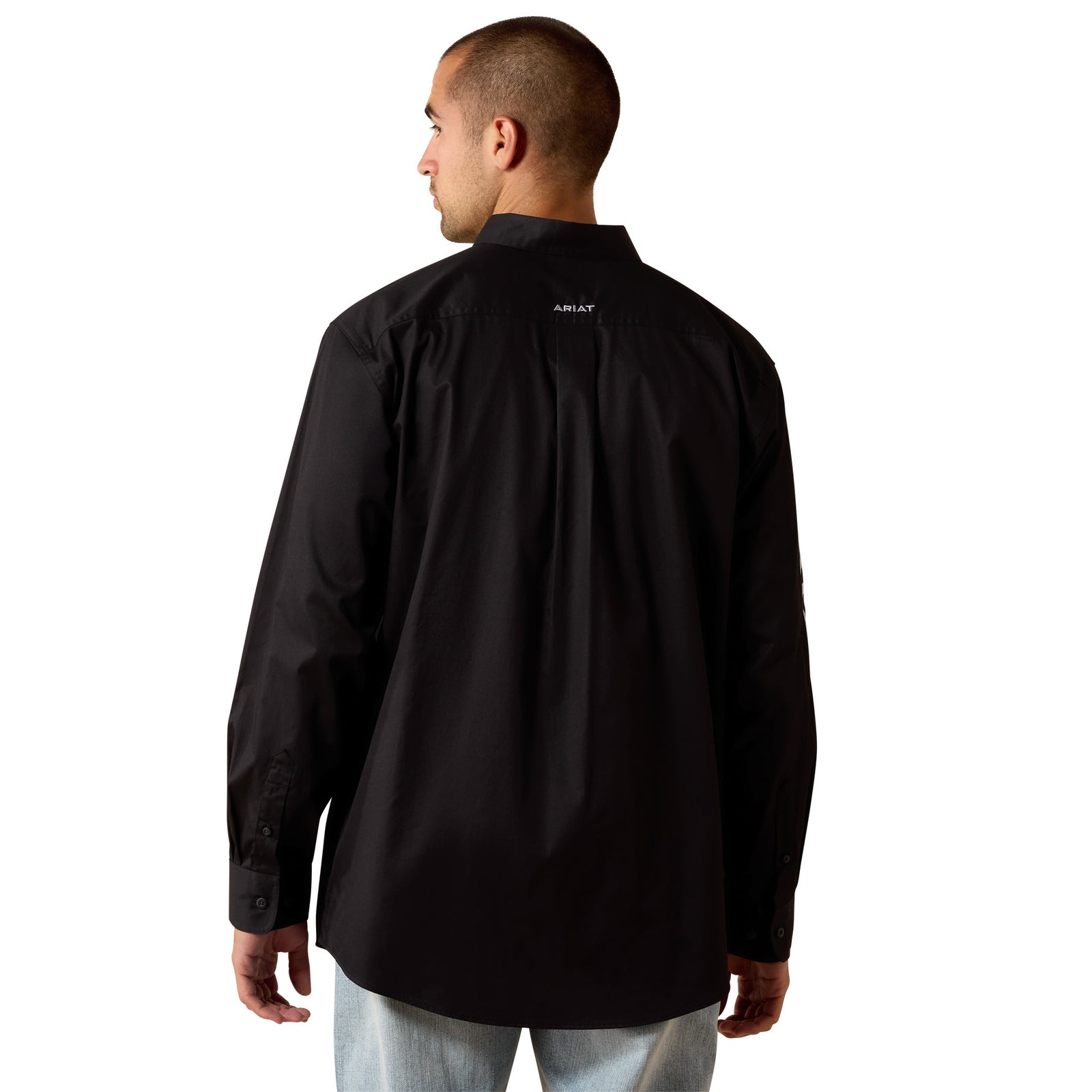 Man wearing a black shirt with a brand logo on the back against a white background