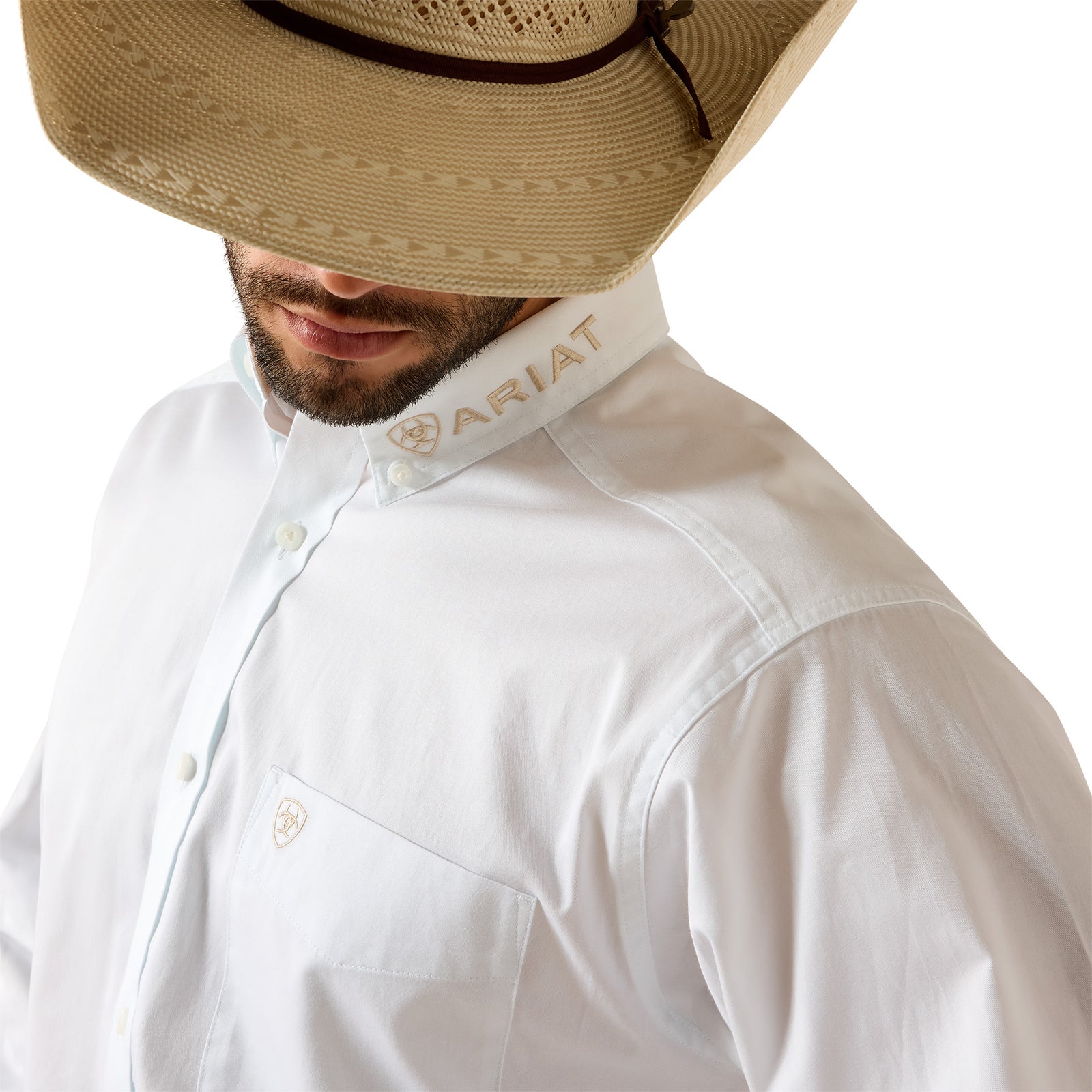 Person wearing a white shirt with Ariat logo and a straw hat on a white background