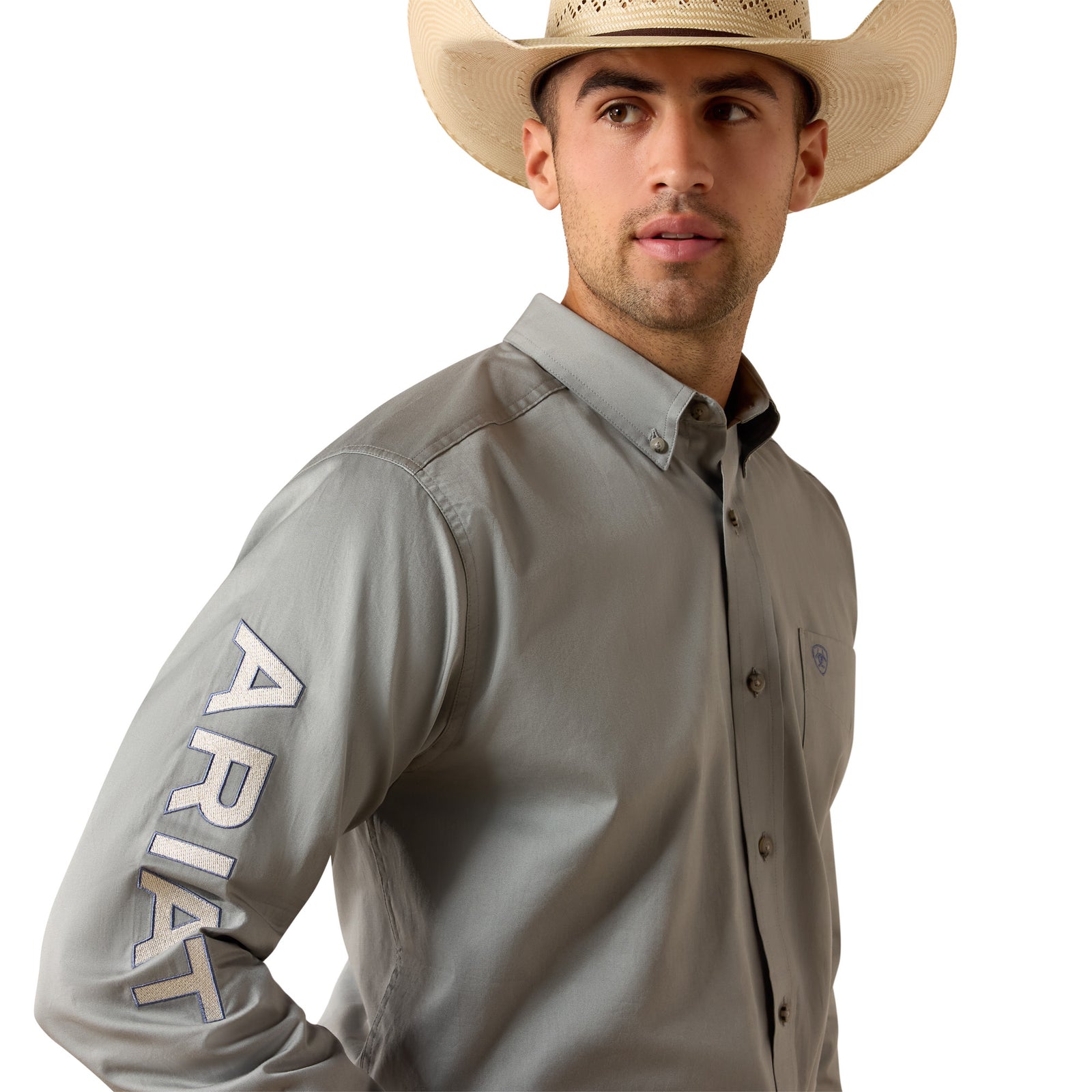 Man wearing a gray shirt with 'Ariat' branding and a cowboy hat on a white background
