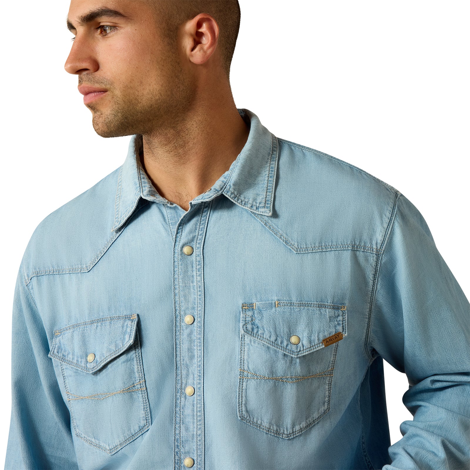 Man wearing a light blue denim shirt on a white background