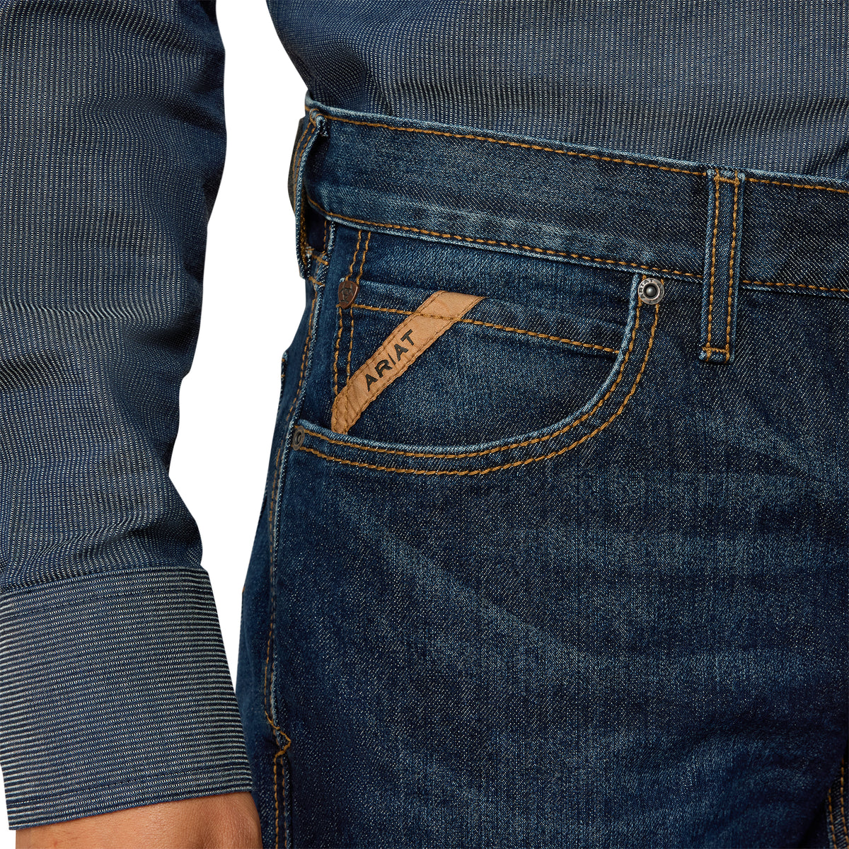 Close-up of blue jeans with a brand logo on the pocket against a white background