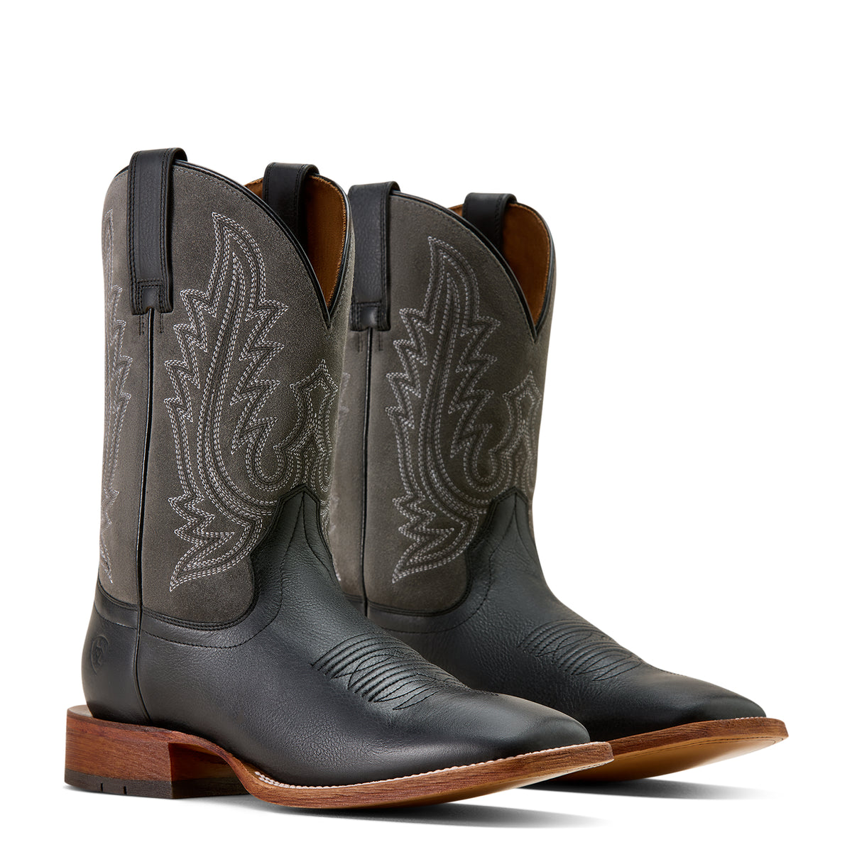 Pair of black cowboy boots with intricate designs on a white background