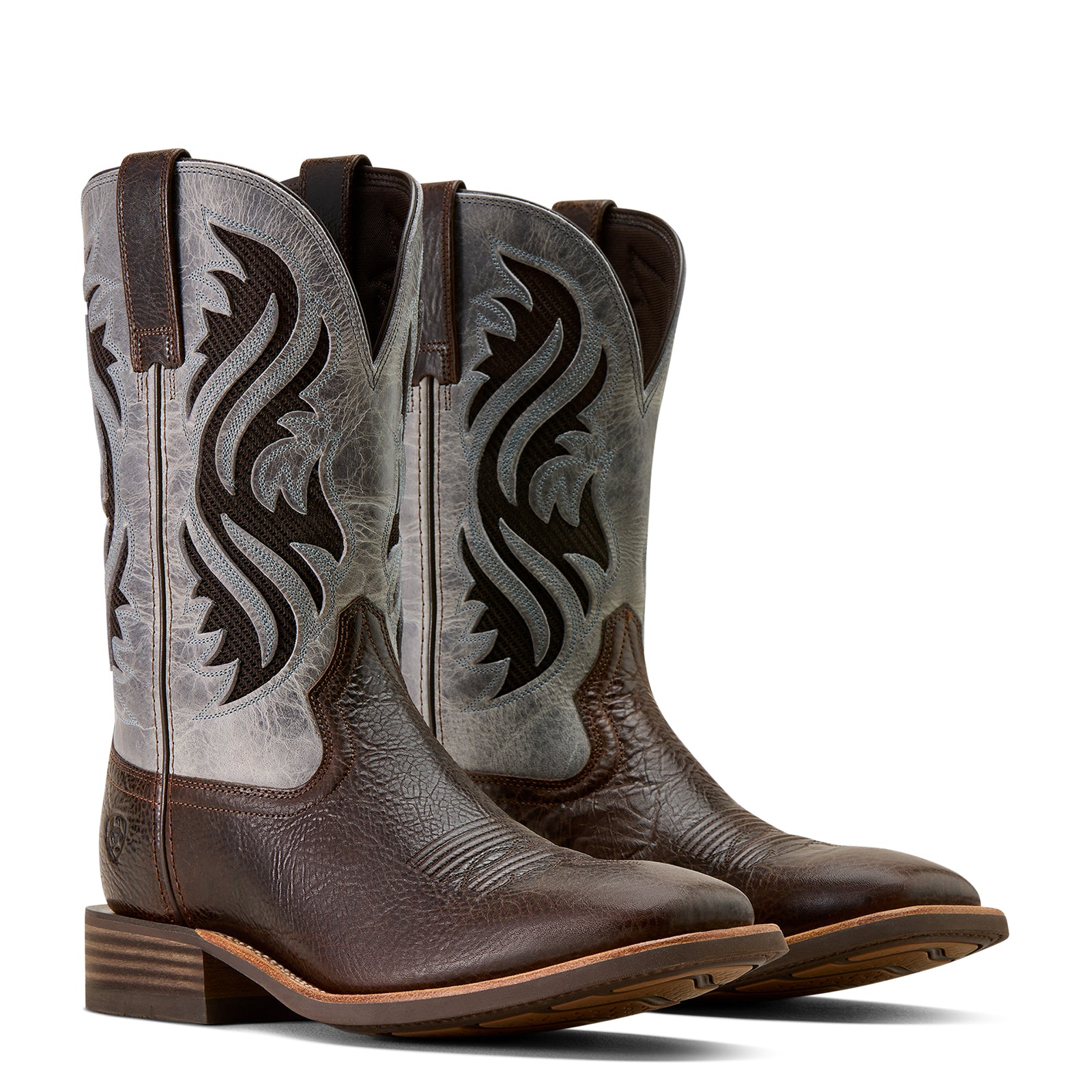 Pair of brown cowboy boots with intricate designs on a white background
