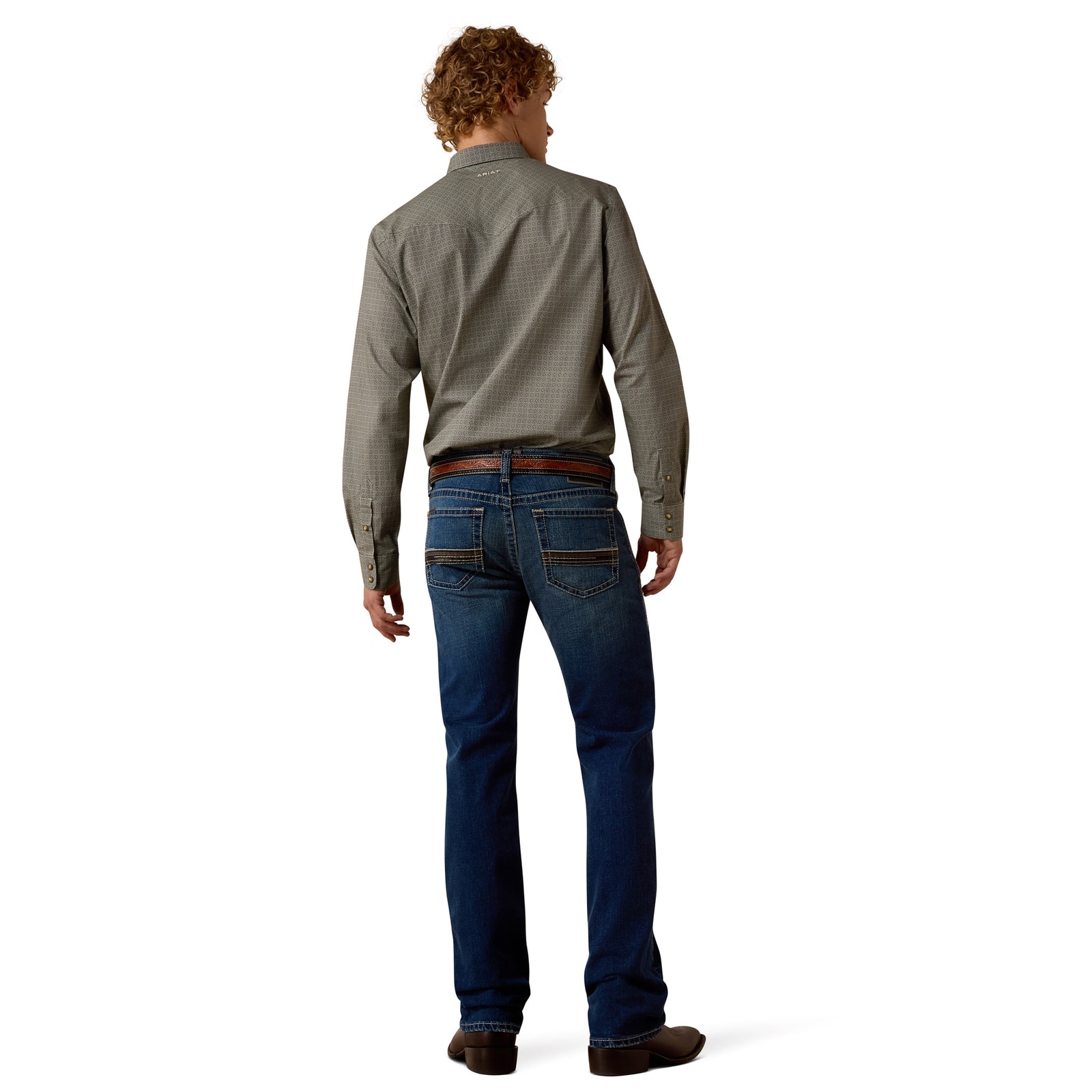 Man wearing a gray shirt and blue jeans on a white background
