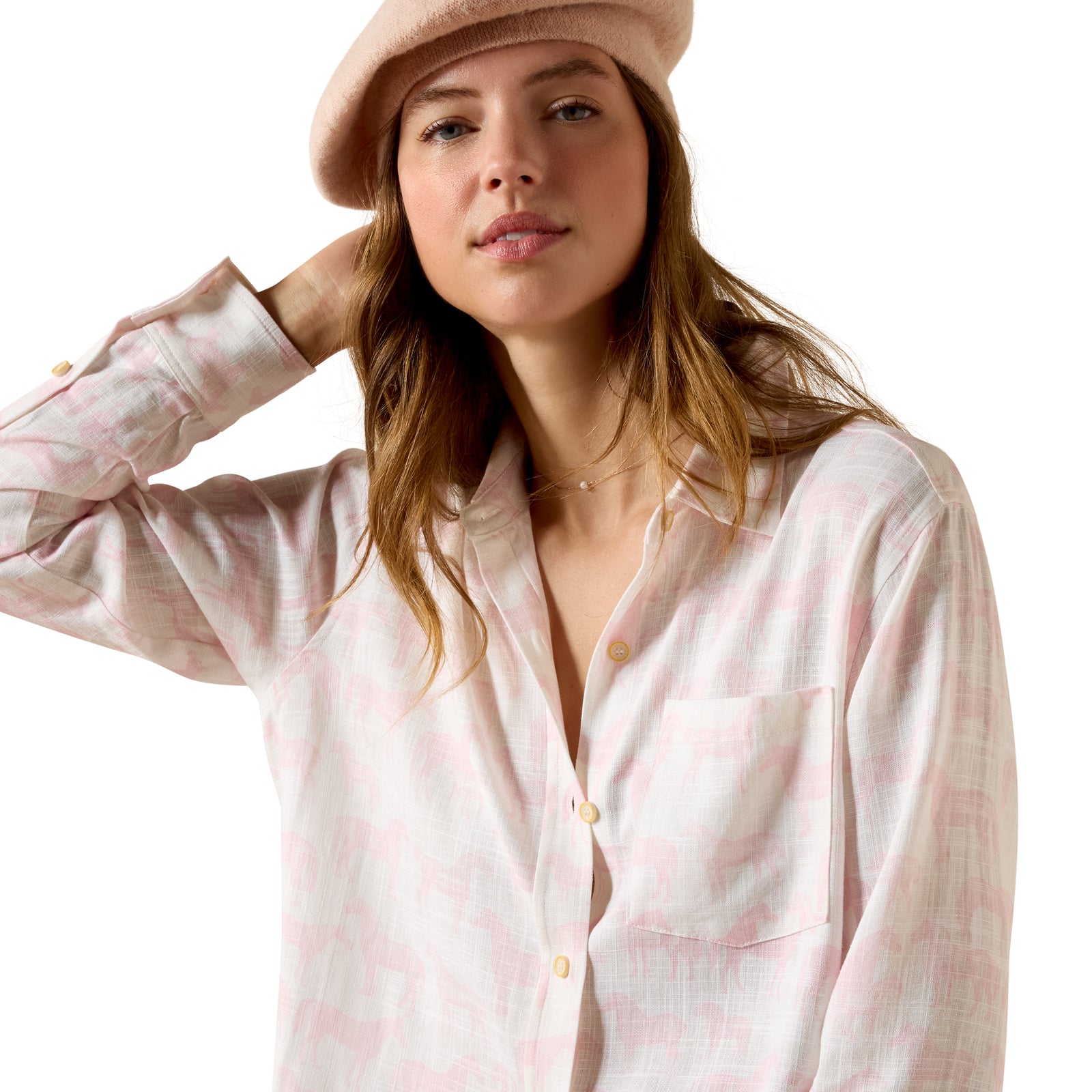 Woman wearing a light pink shirt and beige beret on a white background