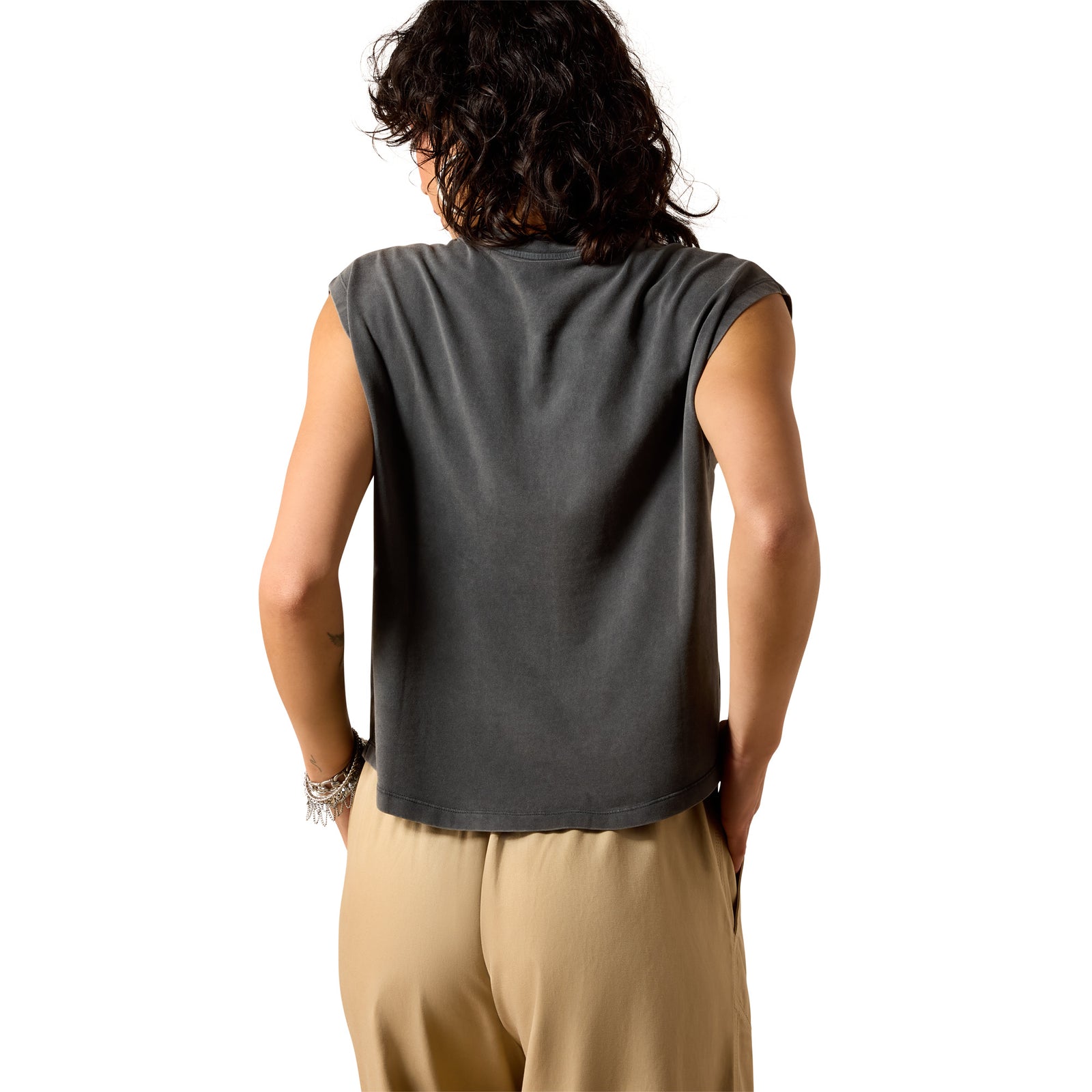 Woman wearing a gray sleeveless top with a graphic design on a white background