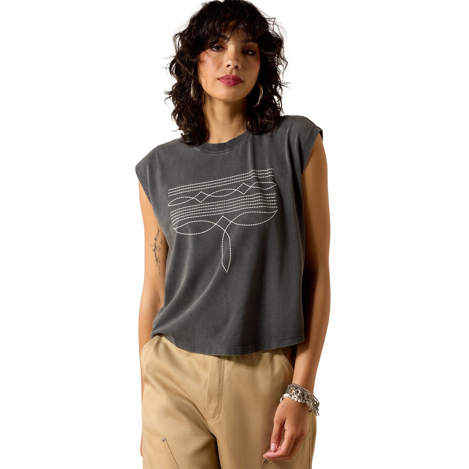 Woman wearing a gray sleeveless top with a graphic design on a white background