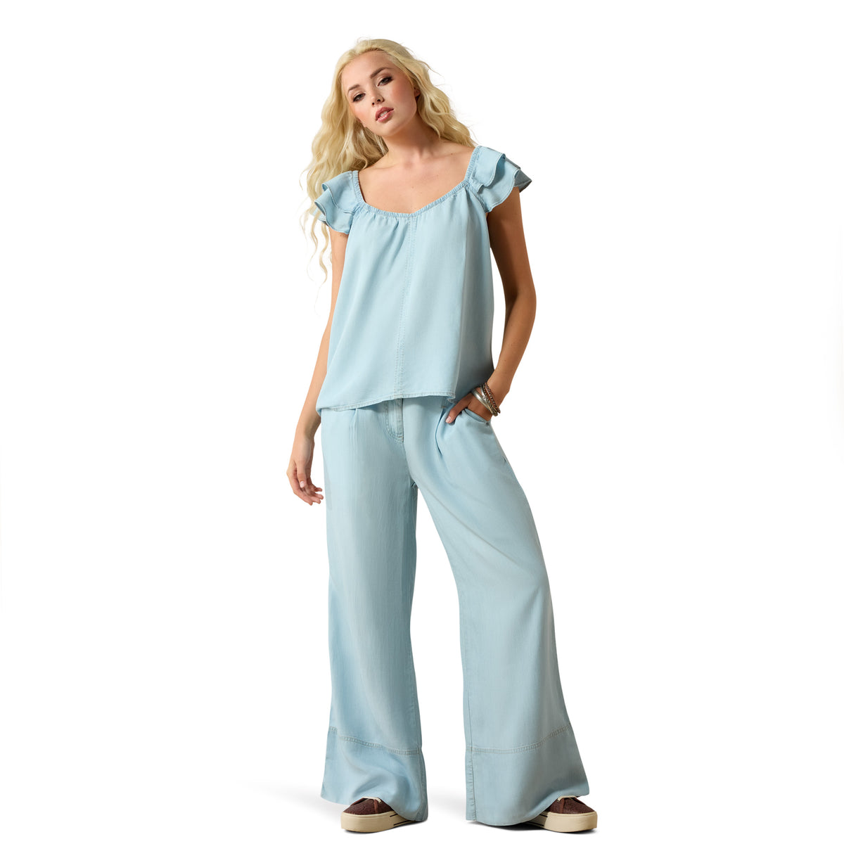 Woman wearing a light blue outfit on a white background