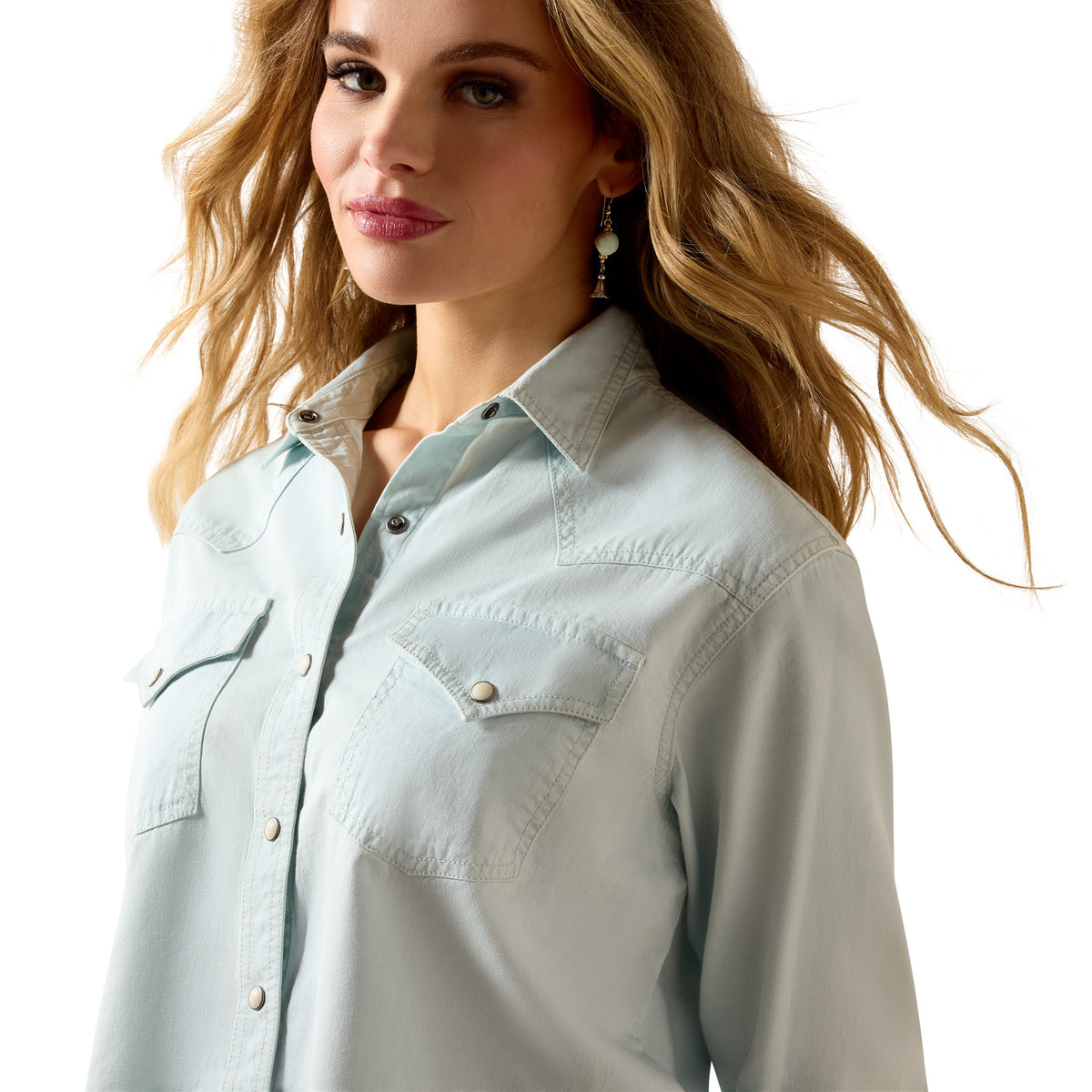 Woman wearing a light blue denim shirt on a white background