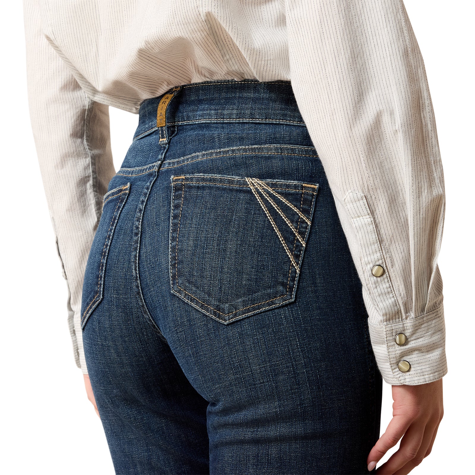 Person wearing blue jeans and a light-colored shirt on a white background