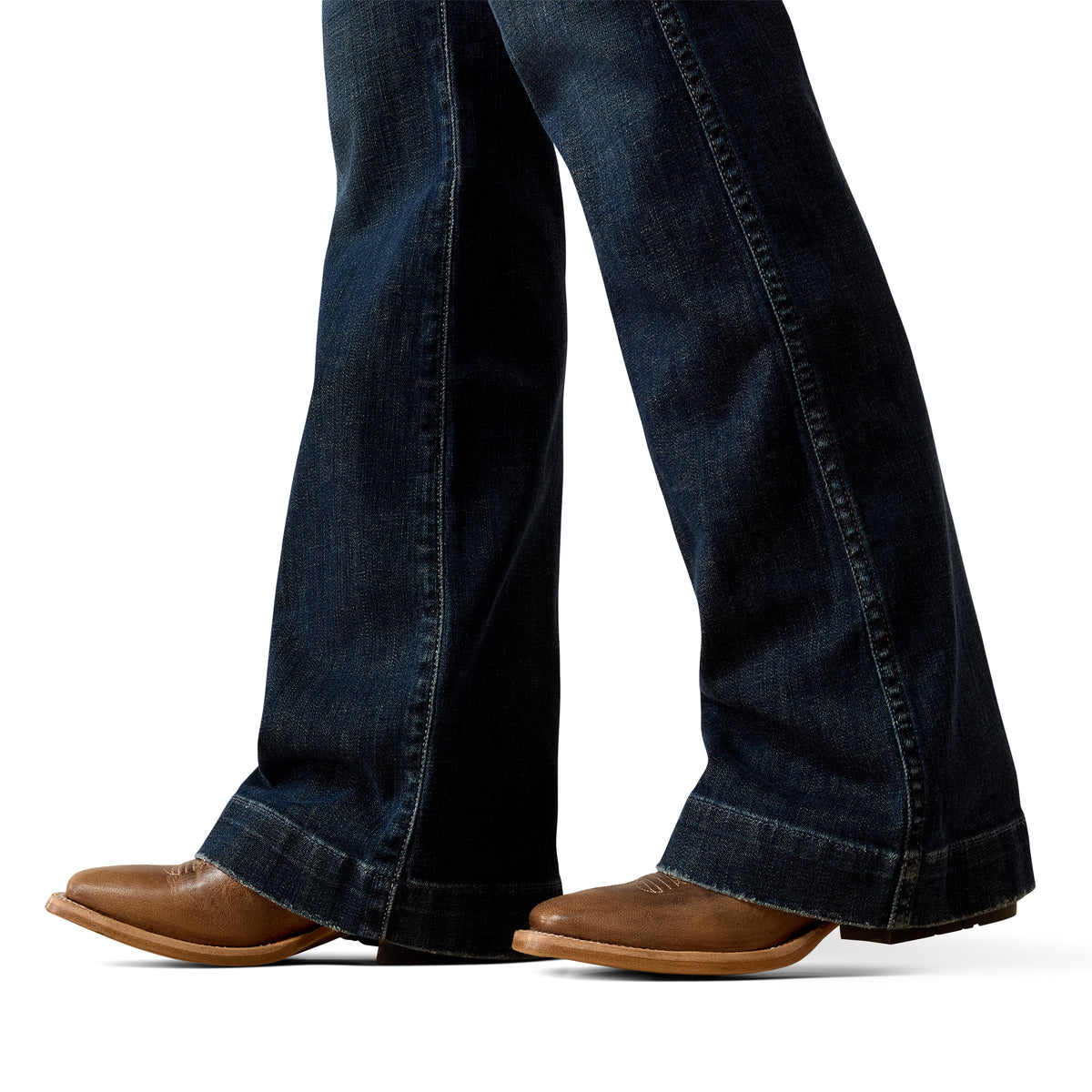 Dark blue jeans worn by a person on a white background