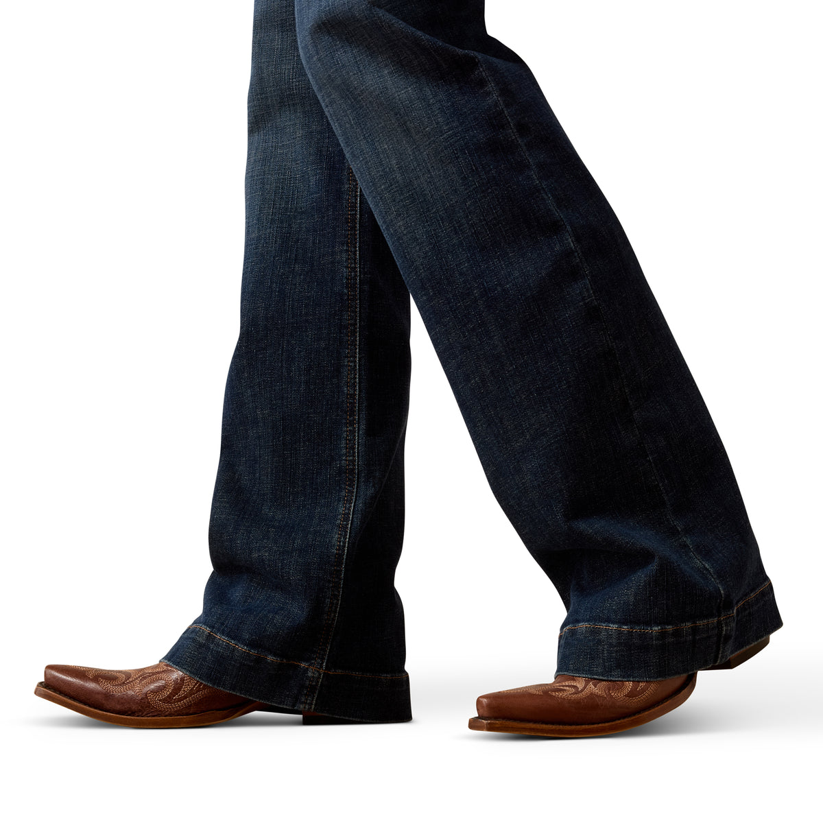 Blue jeans and brown boots on a white background