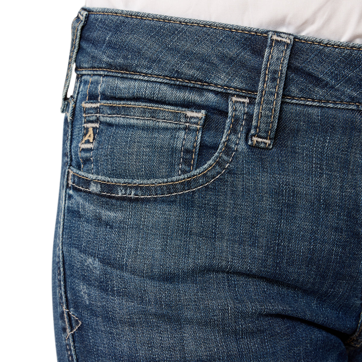 Close-up of blue jeans with a white background