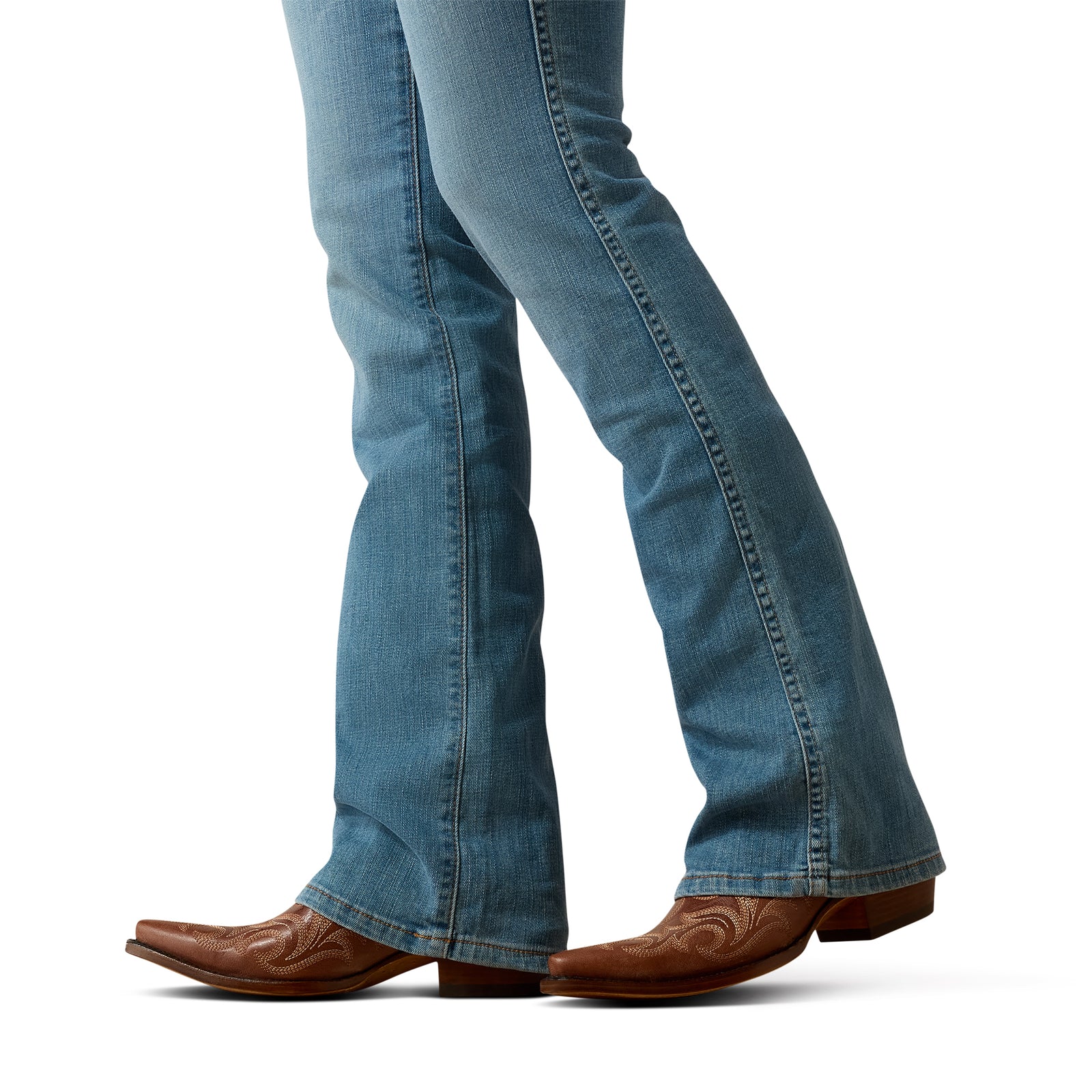 Blue jeans and brown cowboy boots on a white background
