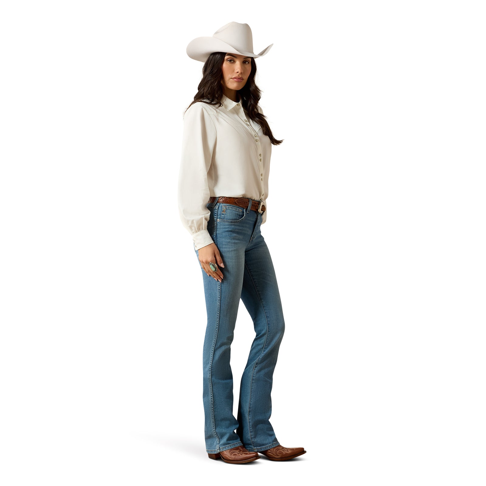 Woman wearing a white cowboy hat, white shirt, blue jeans, and brown boots on a white background
