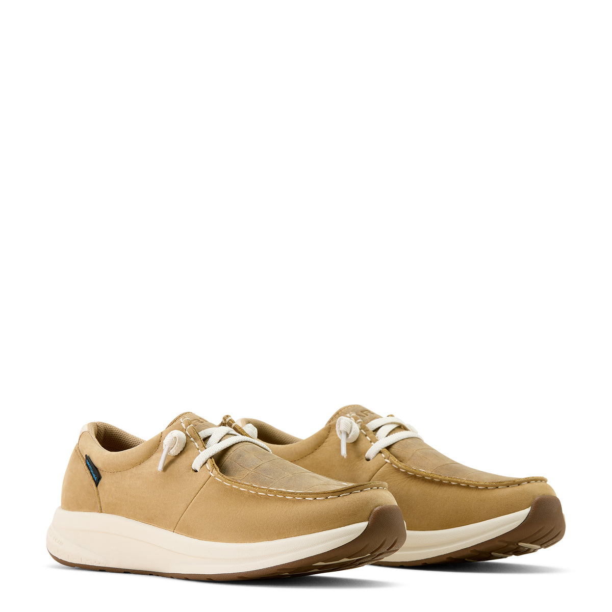 Pair of tan shoes with white soles on a white background