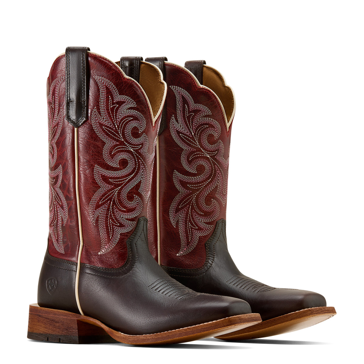 Pair of brown and red cowboy boots with intricate designs on a white background