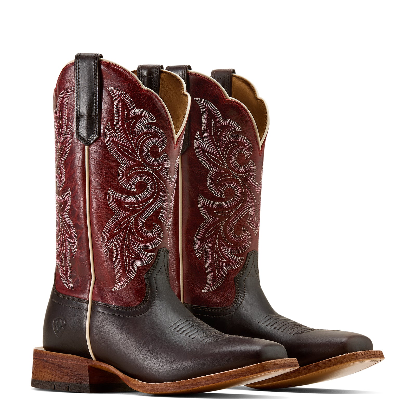 Pair of brown and red cowboy boots with intricate designs on a white background