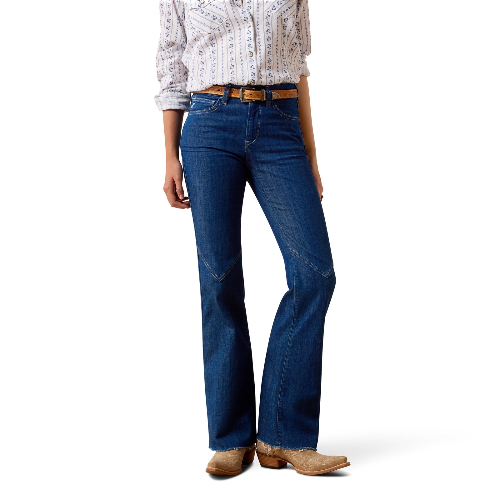 Person wearing blue jeans and a patterned shirt on a white background