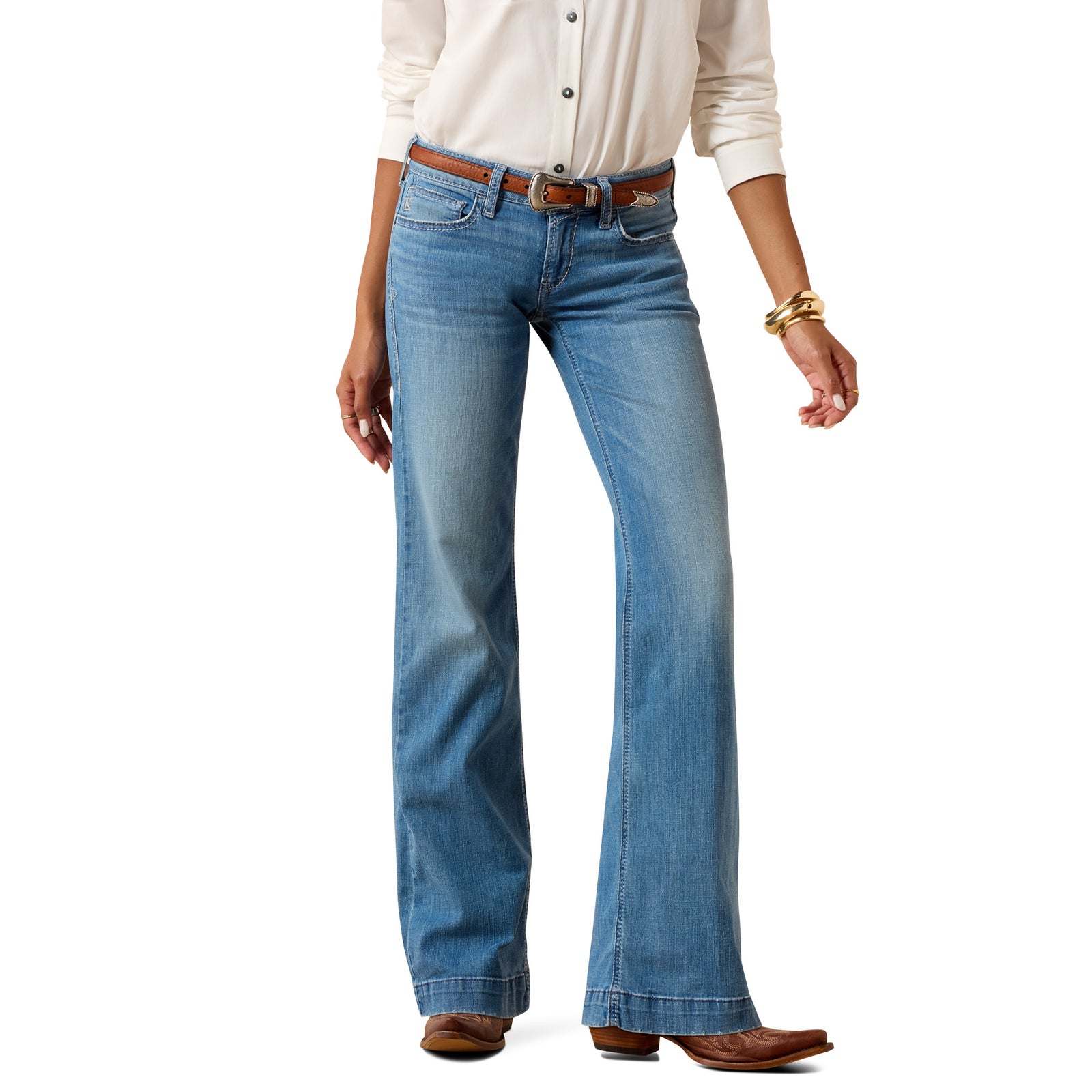 Person wearing blue jeans with a white shirt on a white background