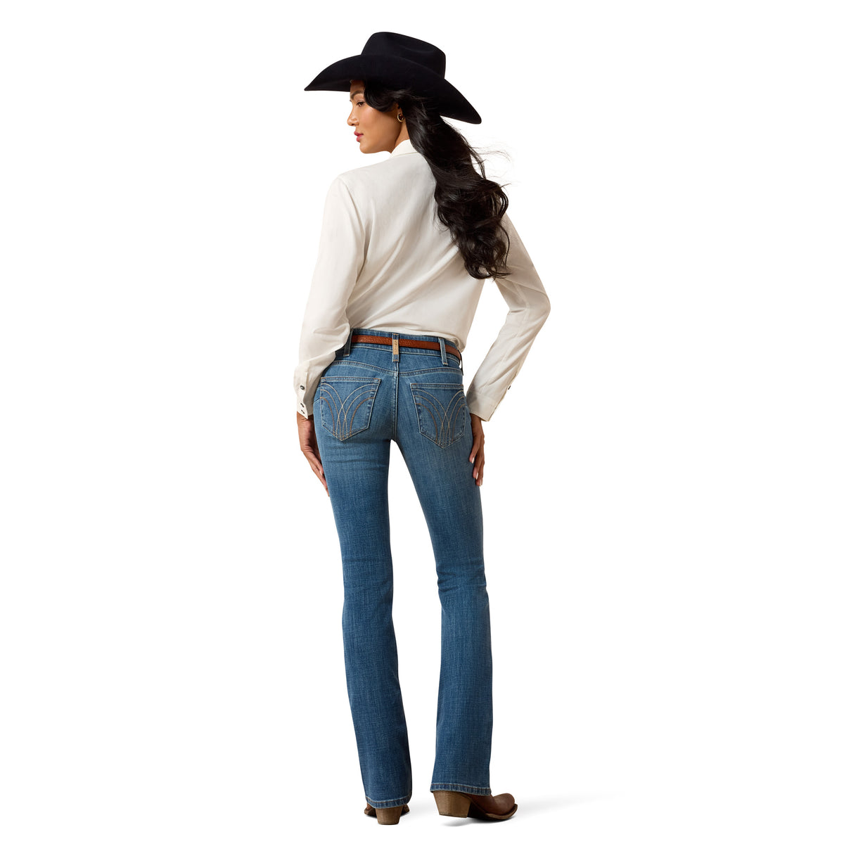 Woman wearing blue jeans and a white shirt with a black cowboy hat on a white background