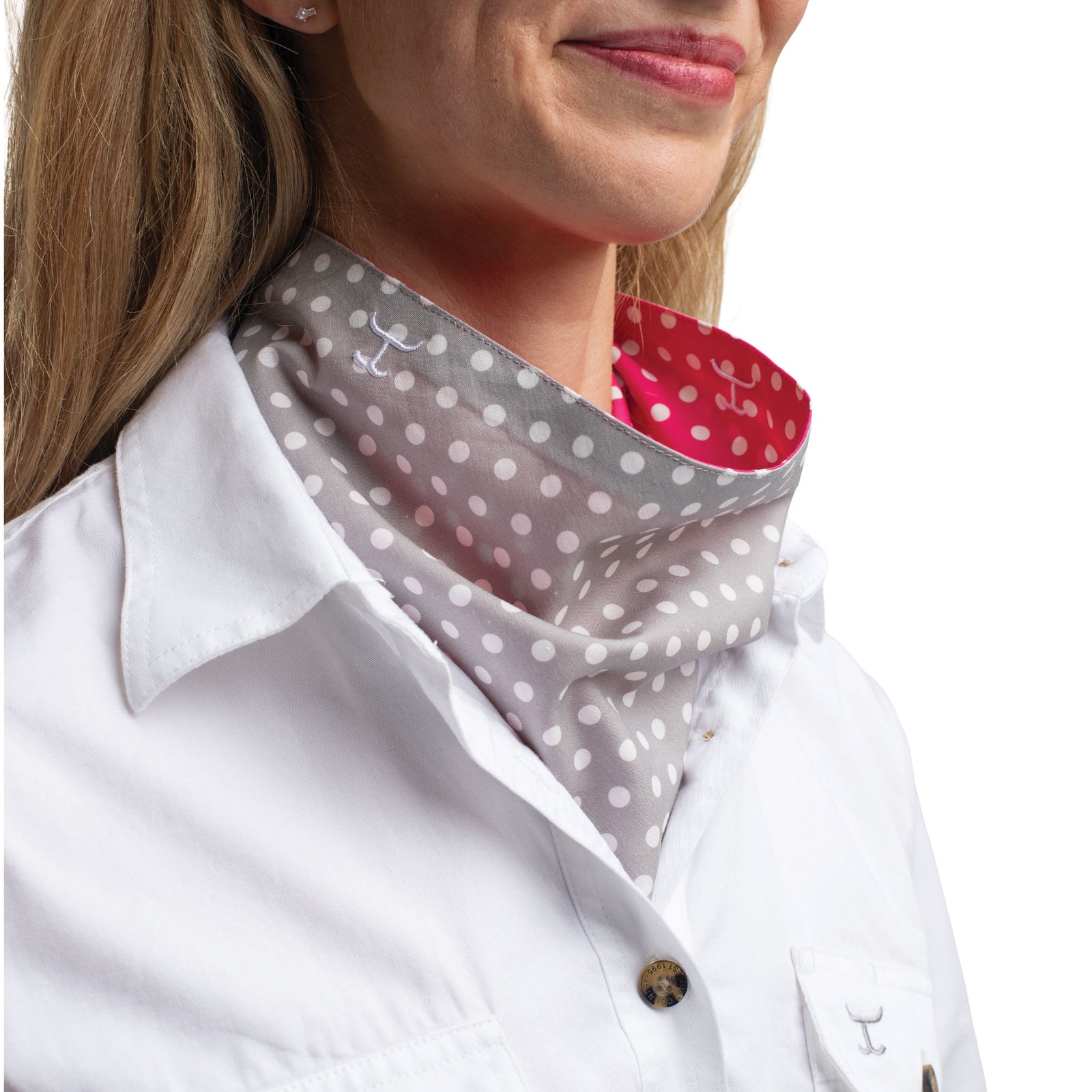 Person wearing a white lab coat with a gray polka dot neckerchief