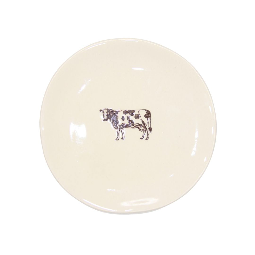 Farm Design Set of 4 Small Ceramic Plates. Round ceramic plate with a cow design on a white background