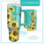 Lisa Pollock Bee Sunny Mugmazing Cups. Turquoise travel mug with sunflower design on a white background
