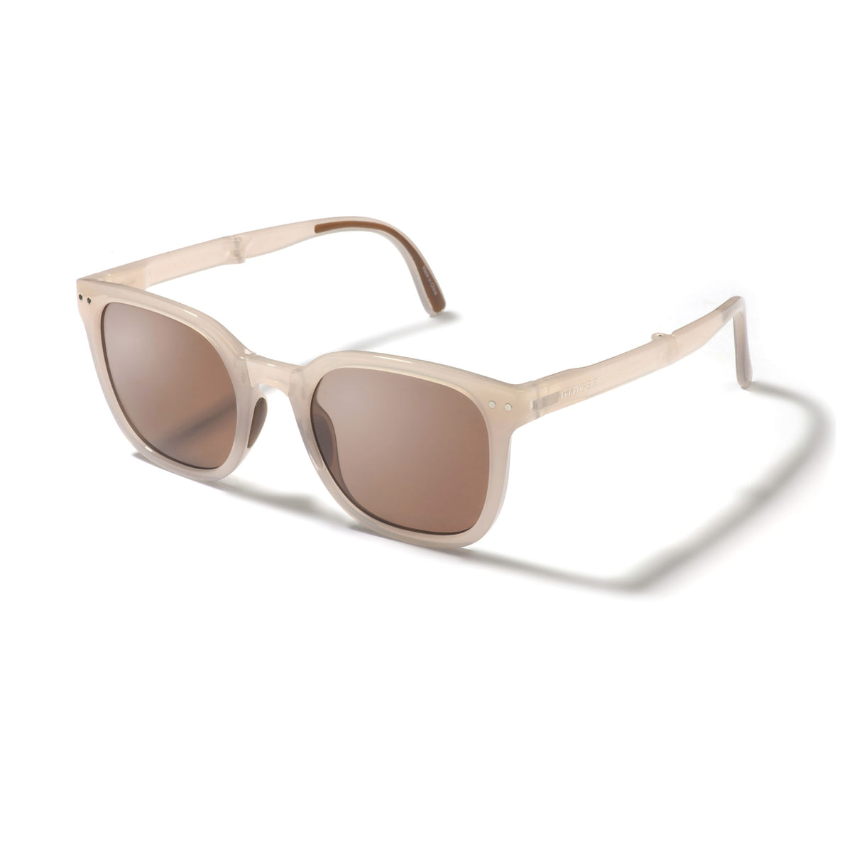 Beige sunglasses with brown lenses on a white background