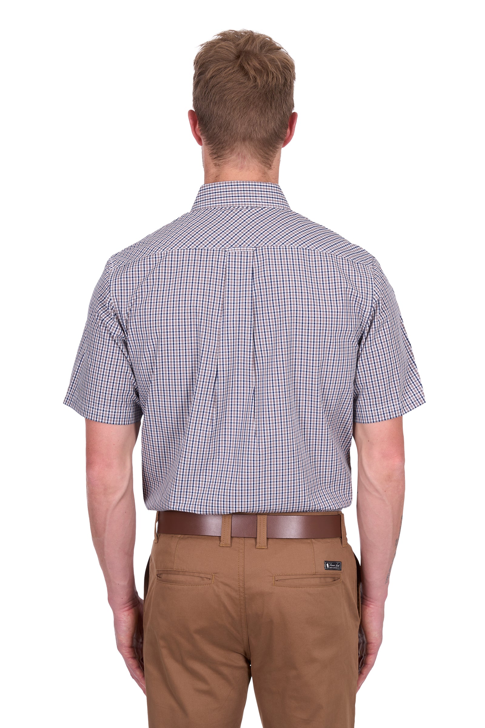 Thomas Cook Men's Will S/S Shirt. Man wearing a checkered shirt and brown pants on a white background