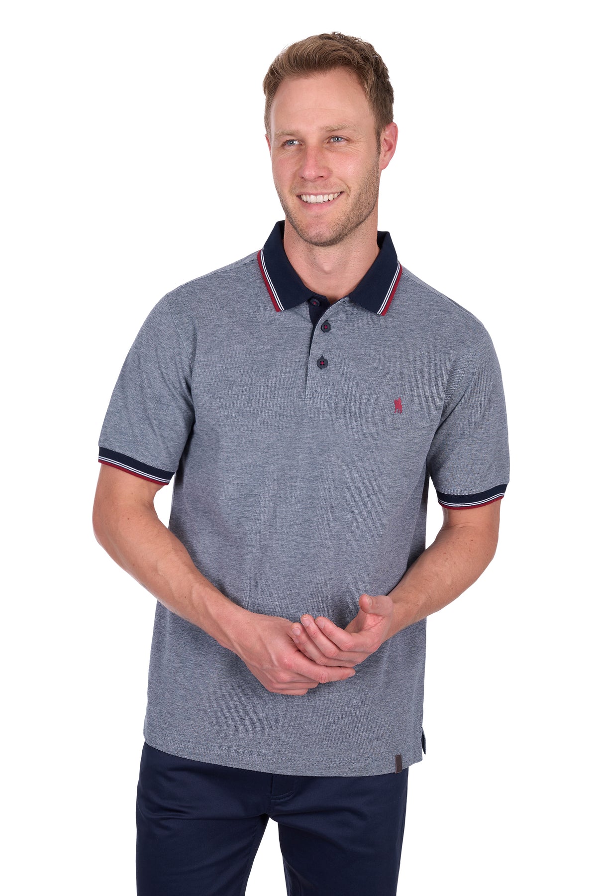 Man wearing a Thomas Cook Men&#39;s Dan Tailored S/S Polo. Navy Marle polo shirt with navy accents on a white background