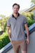 Man wearing a Thomas Cook Men's Dan Tailored S/S Polo. Navy Marle polo shirt with navy accents on a white background
