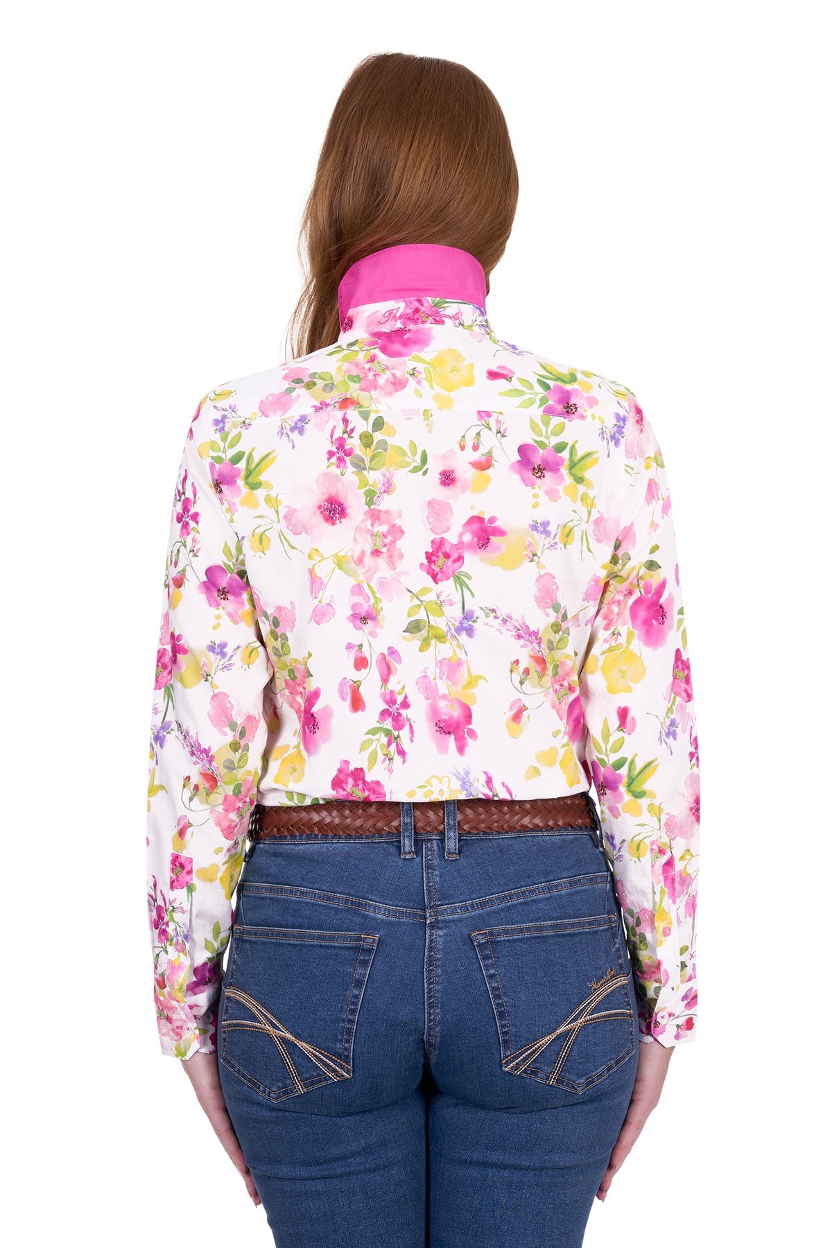 Thomas Cook Women's Mila L/S Western Shirt. Person wearing a colorful floral shirt and blue jeans on a white background